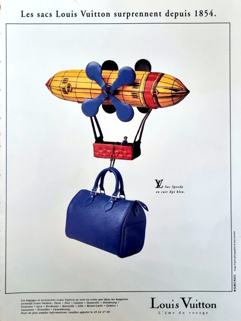 Vintage Louis Vuitton advertisement featuring the Speedy handbag in blue Epi leather suspended beneath a whimsical airship illustration. The French tagline reads “Les sacs Louis Vuitton surprennent depuis 1854,” referencing the brand’s long history of luxury luggage and travel accessories. The advert reflects Louis Vuitton’s creative marketing style and emphasis on craftsmanship, travel heritage, and distinctive leather design.
