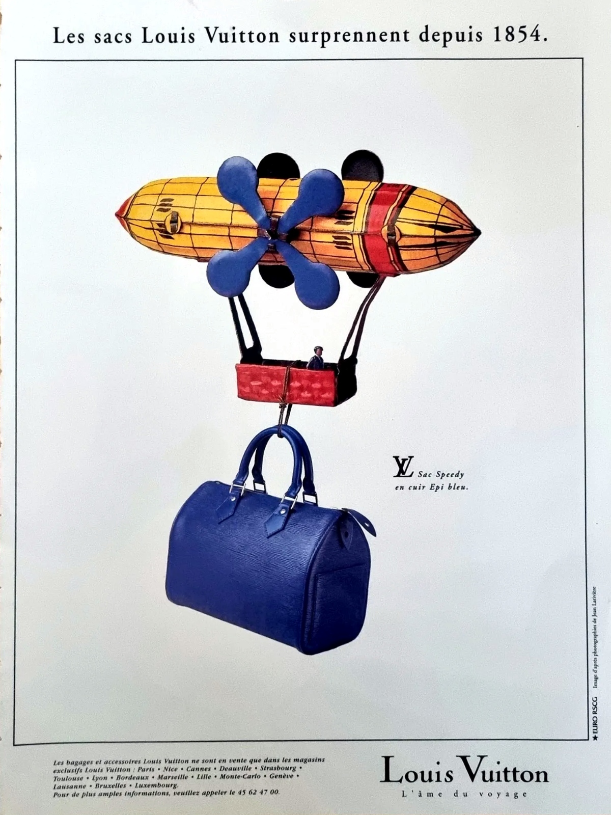 Vintage Louis Vuitton advertisement featuring the Speedy handbag in blue Epi leather suspended beneath a whimsical airship illustration. The French tagline reads “Les sacs Louis Vuitton surprennent depuis 1854,” referencing the brand’s long history of luxury luggage and travel accessories. The advert reflects Louis Vuitton’s creative marketing style and emphasis on craftsmanship, travel heritage, and distinctive leather design.